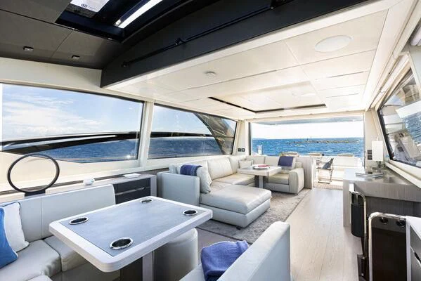 a room with a couch and a table and a large window aboard SURVIVOR OF LONDON Yacht for Sale