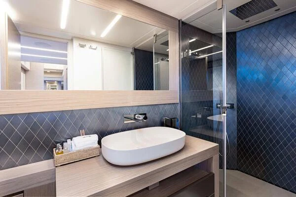 a bathroom with a sink and a shower aboard SURVIVOR OF LONDON Yacht for Sale