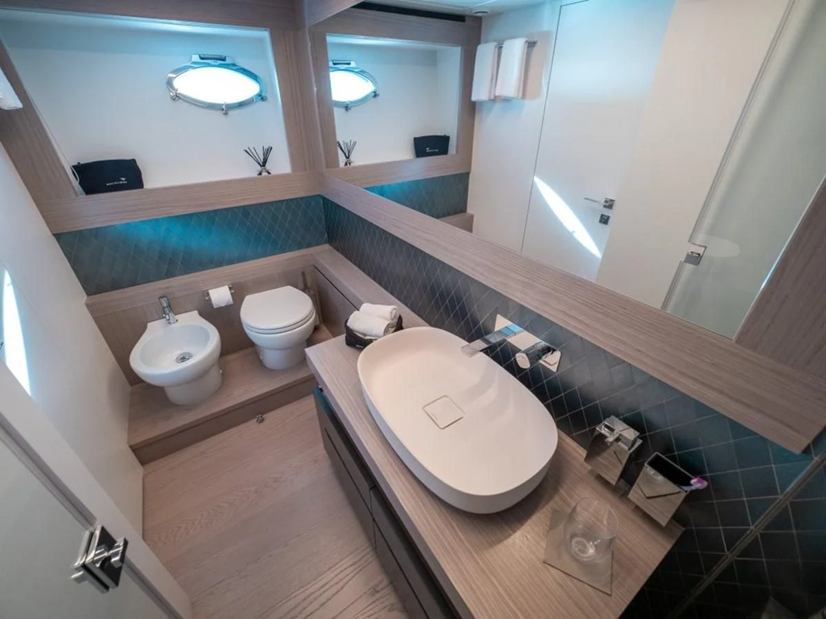 a bathroom with a sink and a mirror aboard SURVIVOR OF LONDON Yacht for Sale