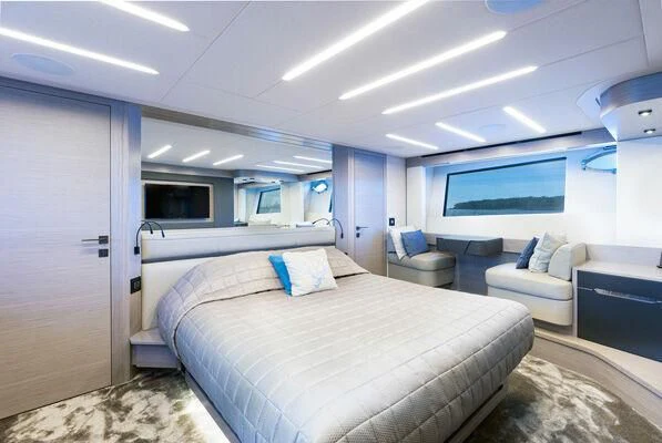 a room with a bed and a chair aboard SURVIVOR OF LONDON Yacht for Sale