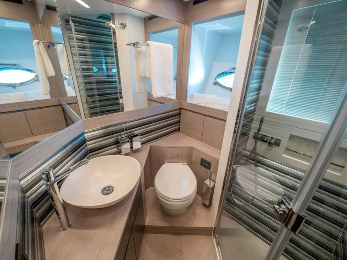 a bathroom with a glass shower aboard SURVIVOR OF LONDON Yacht for Sale