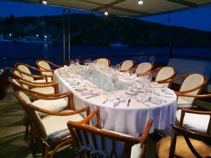 a table set for a dinner aboard IRAKLIS L Yacht for Charter