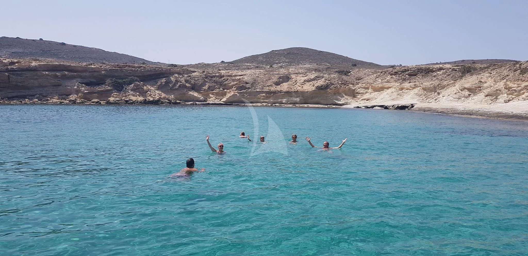 a group of people swimming in a body of water aboard IRAKLIS L Yacht for Charter
