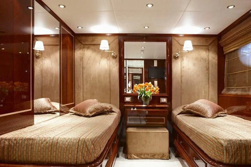 a bedroom with a bed and a mirror aboard IRAKLIS L Yacht for Charter