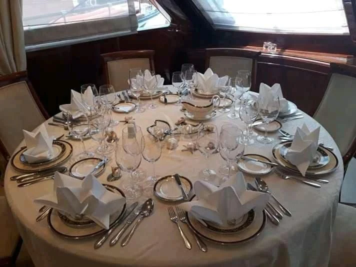 a table with place settings aboard IRAKLIS L Yacht for Charter