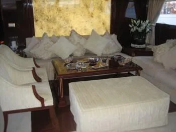 a room with a bed and a coffee table aboard IRAKLIS L Yacht for Charter