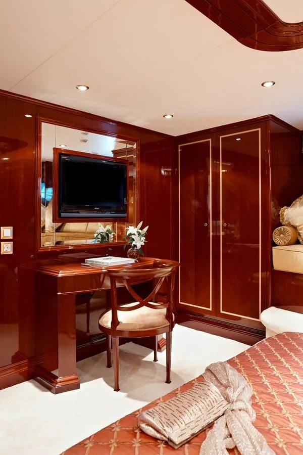 a room with a table and tv aboard IRAKLIS L Yacht for Charter