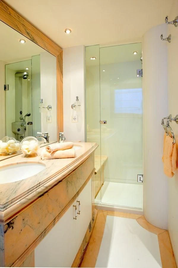 a bathroom with a sink and a shower aboard IRAKLIS L Yacht for Charter