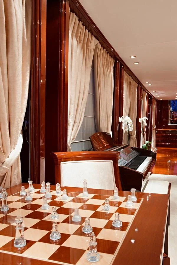 a piano and a table with candles aboard IRAKLIS L Yacht for Charter