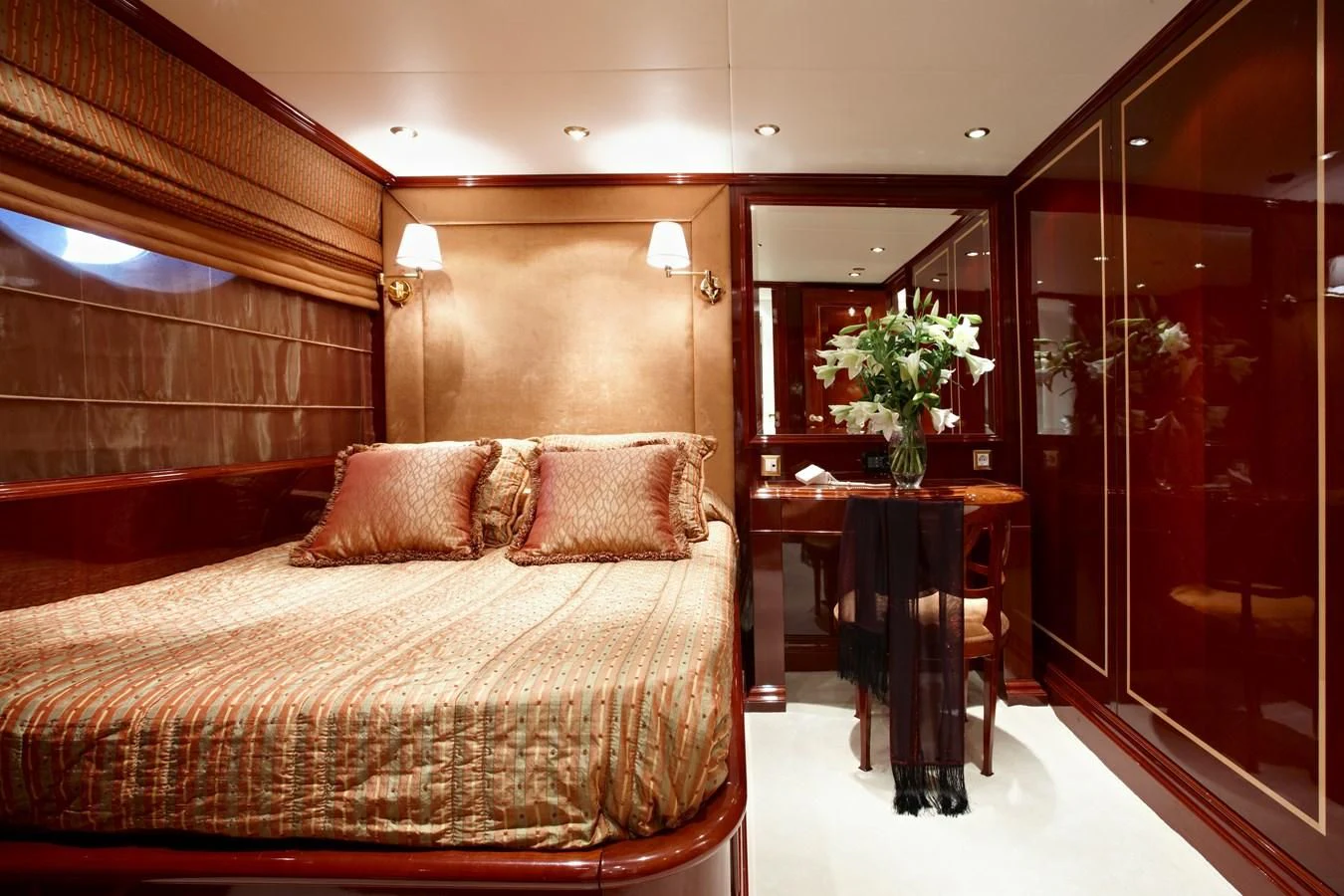 a bed with a table and chairs aboard IRAKLIS L Yacht for Charter