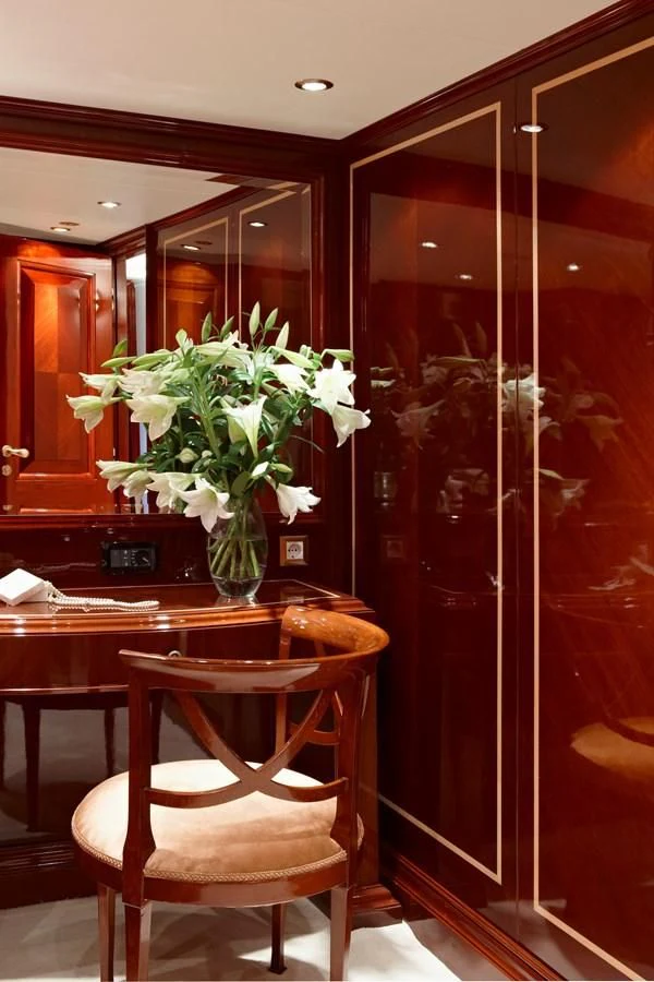 a vase of white flowers sits on a table aboard IRAKLIS L Yacht for Charter