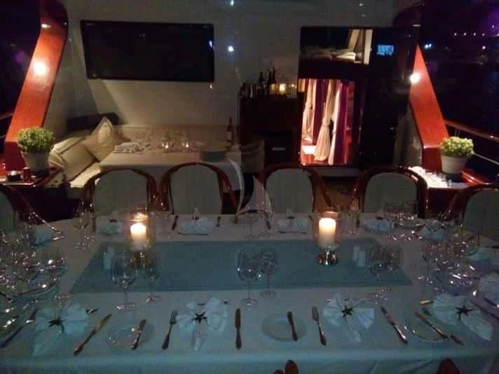 a table with many glasses and candles aboard IRAKLIS L Yacht for Charter