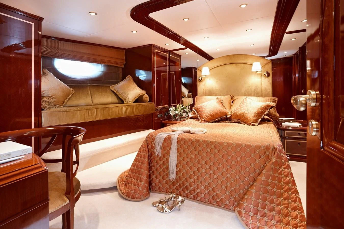 a bedroom with a bed and a couch aboard IRAKLIS L Yacht for Charter