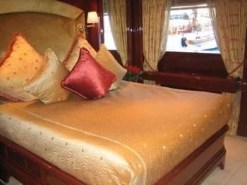 a bed with pillows aboard IRAKLIS L Yacht for Charter