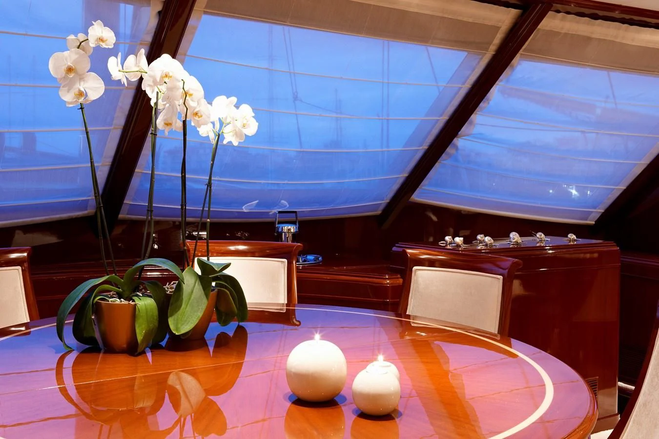 a room with a table and a vase with flowers on it aboard IRAKLIS L Yacht for Charter