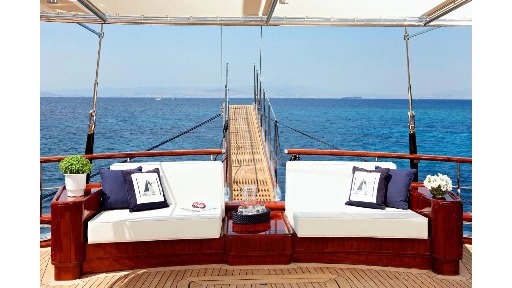 a room with a bed and a table and a chair aboard IRAKLIS L Yacht for Charter