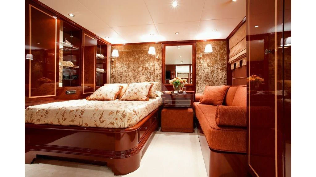 a bedroom with a bed and a mirror aboard IRAKLIS L Yacht for Charter