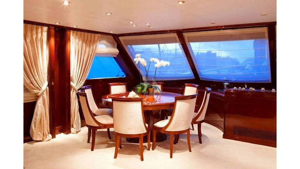 a room with a table and chairs aboard IRAKLIS L Yacht for Charter