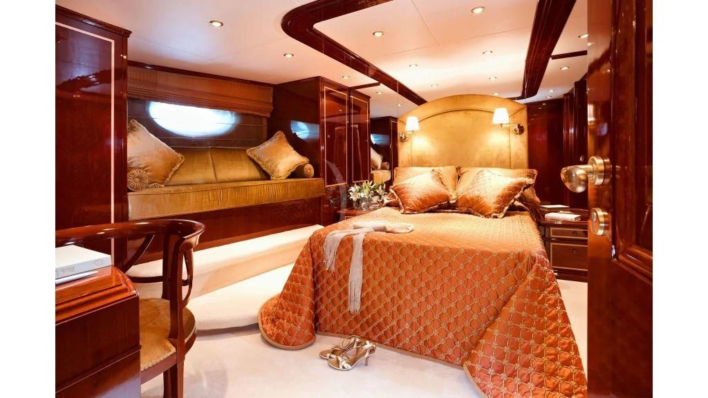 a bedroom with a bed and a couch aboard IRAKLIS L Yacht for Charter