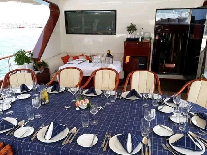 a table set with place settings aboard IRAKLIS L Yacht for Charter