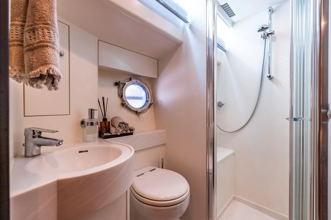 a bathroom with a toilet sink and a mirror aboard OYSTER Yacht for Sale