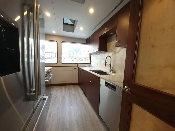 a kitchen with wooden cabinets aboard SOUTHERN BREW Yacht for Sale
