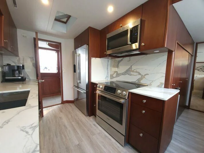 a kitchen with wooden cabinets aboard SOUTHERN BREW Yacht for Sale