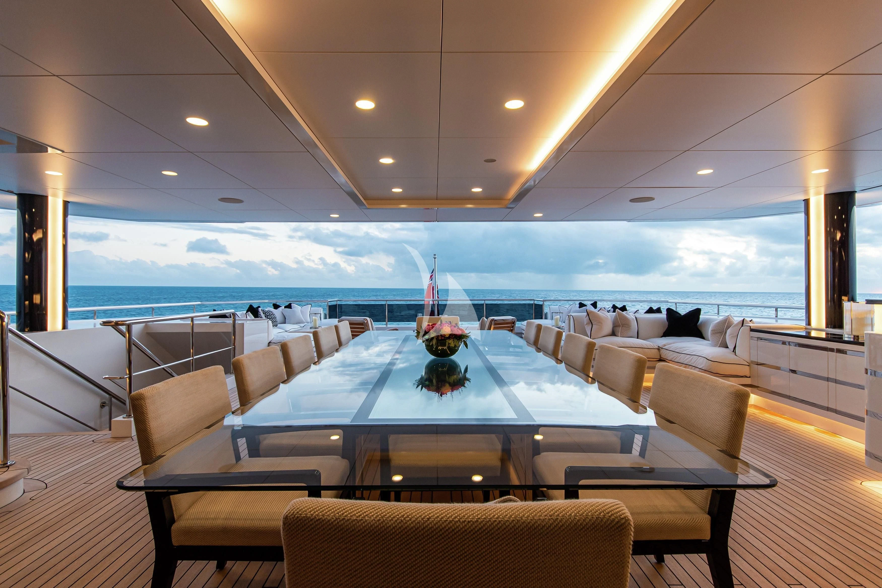 a large room with a large table and chairs aboard NORTH STAR Yacht for Sale
