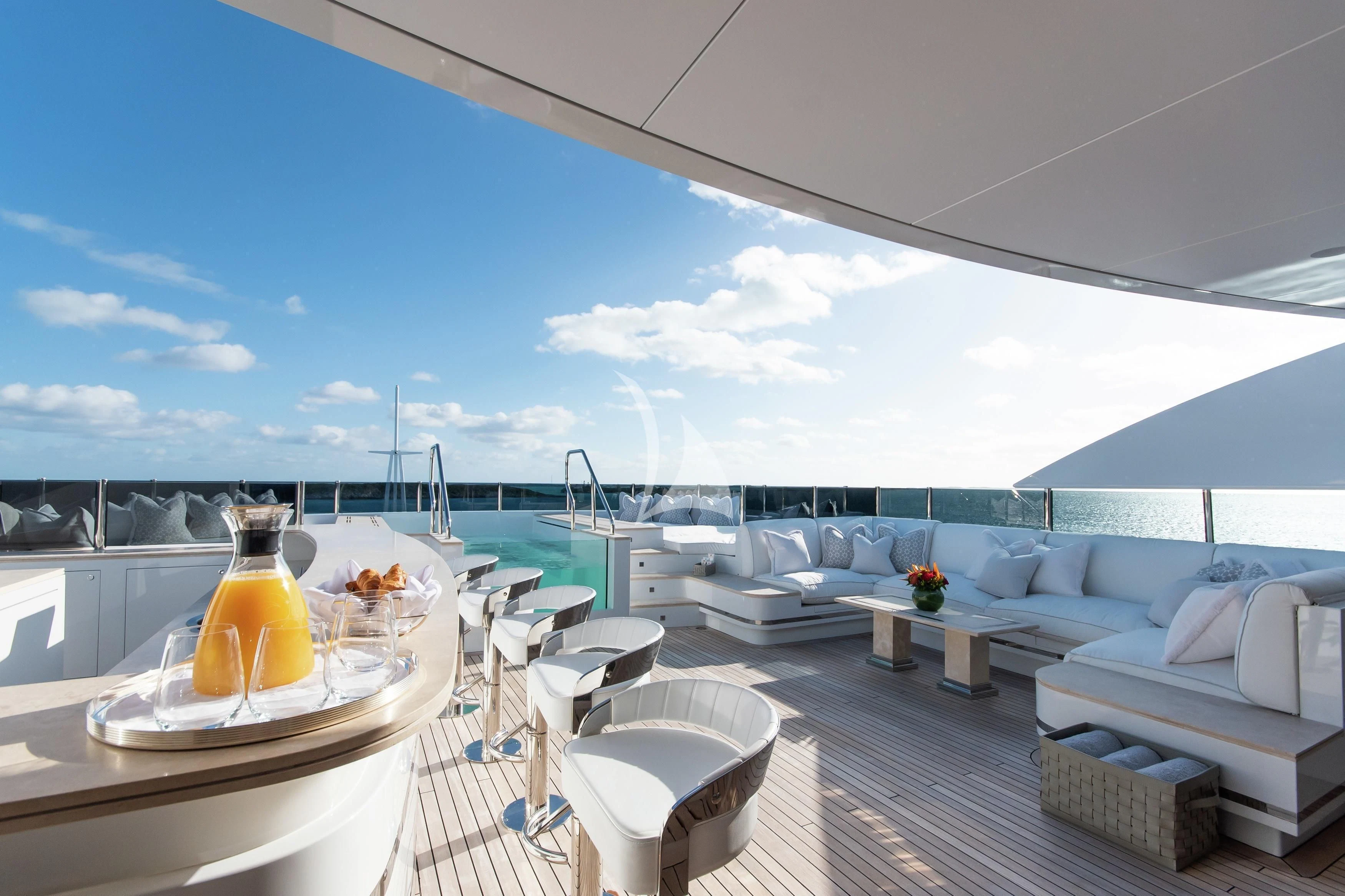 a large white lounge area with a large white lounge chair and a large white lounge chair with a aboard NORTH STAR Yacht for Sale
