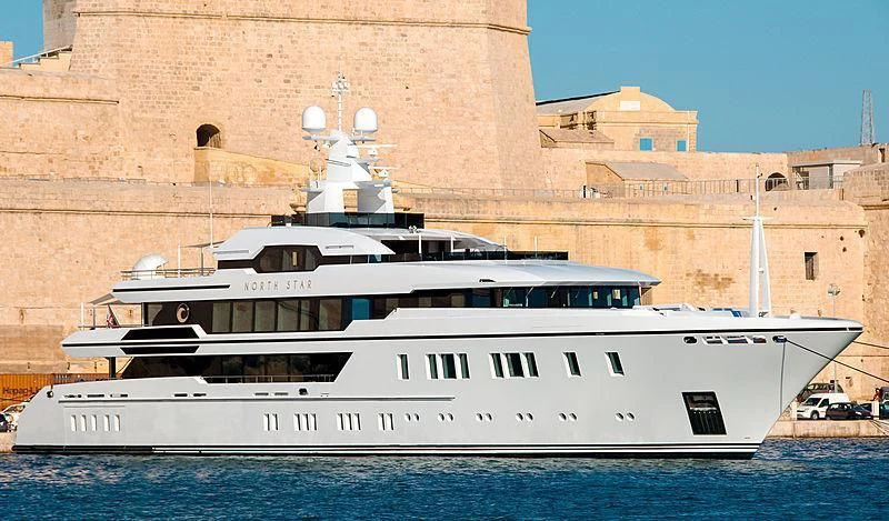 a large white boat in front of a large building aboard NORTH STAR Yacht for Sale