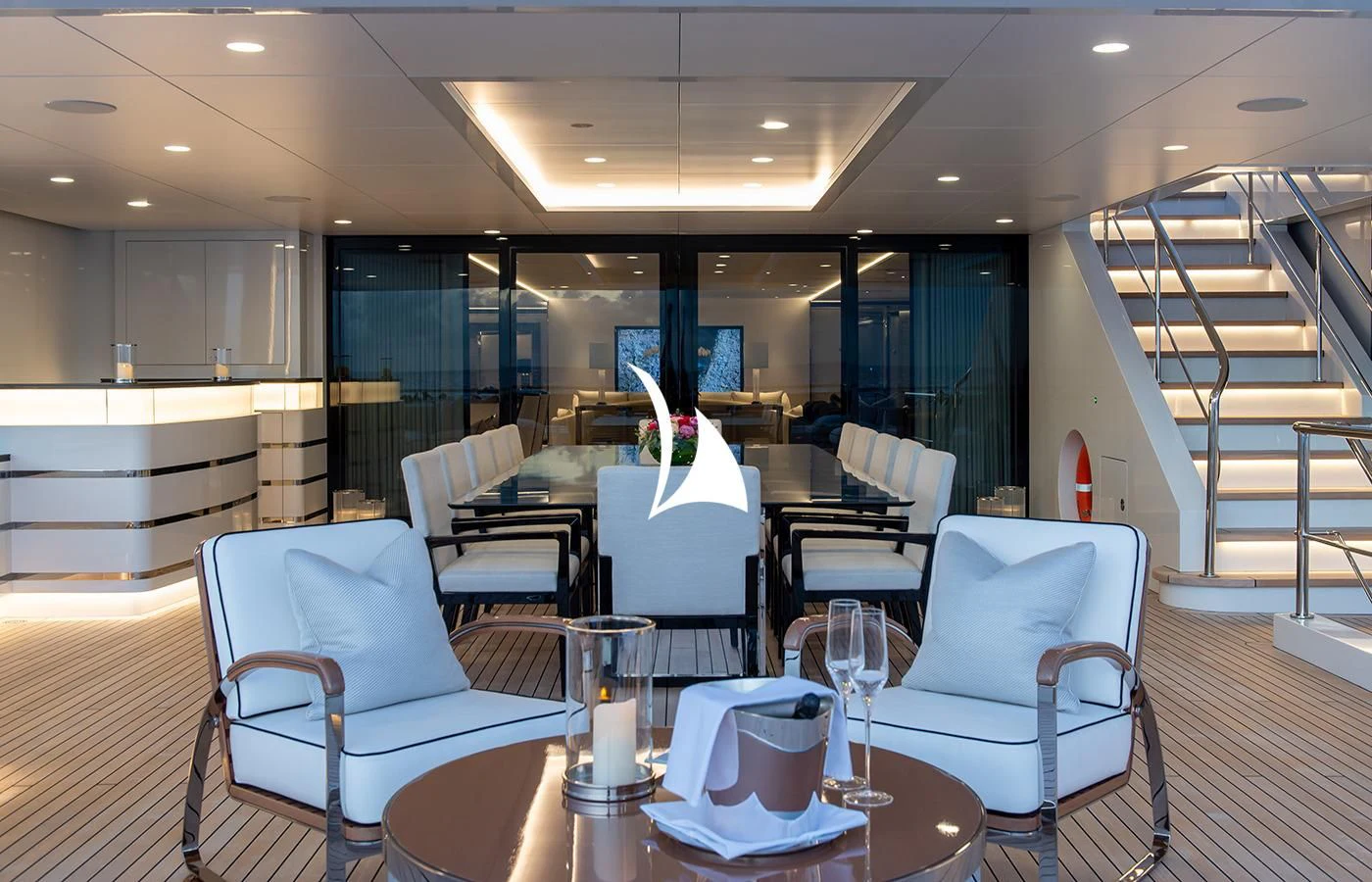 a room with a table chairs and a staircase aboard NORTH STAR Yacht for Sale