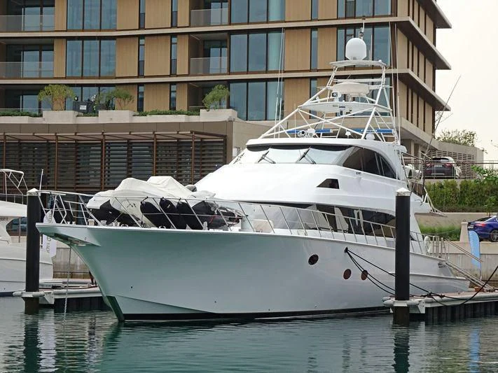 a white boat docked aboard BOSS Yacht for Sale