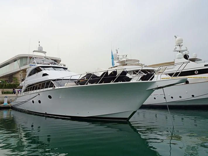 a white yacht docked aboard BOSS Yacht for Sale