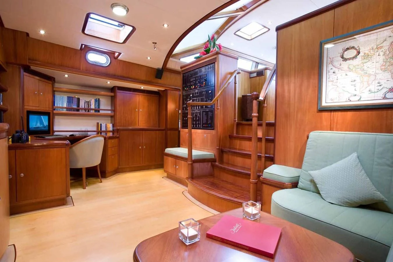 a living room with a bookcase and a couch aboard WHIRLWIND Yacht for Sale