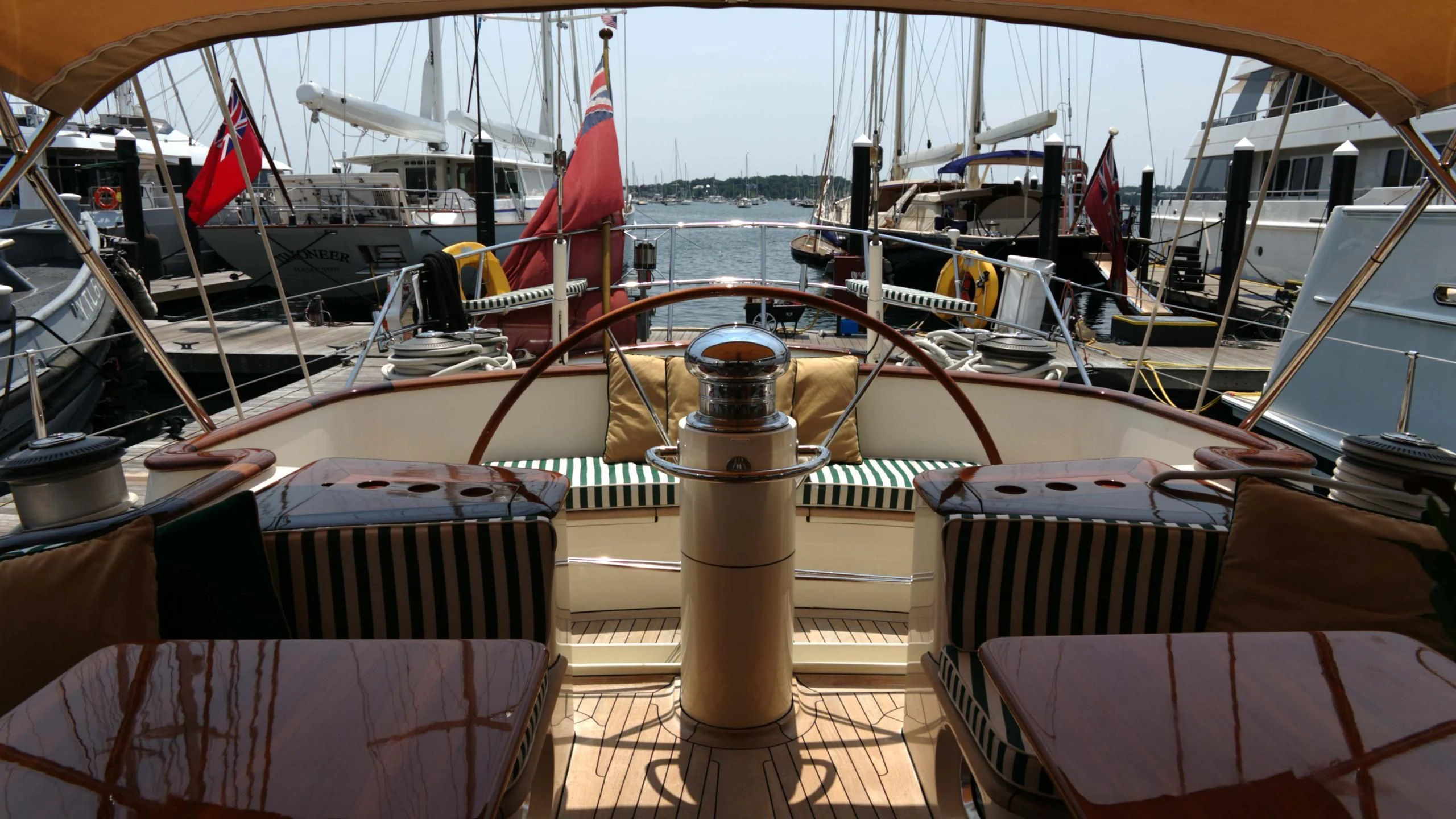 a boat with a flag on the front aboard WHIRLWIND Yacht for Sale