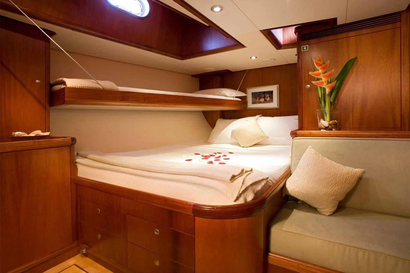 a room with a bed and a plant on the wall aboard WHIRLWIND Yacht for Sale