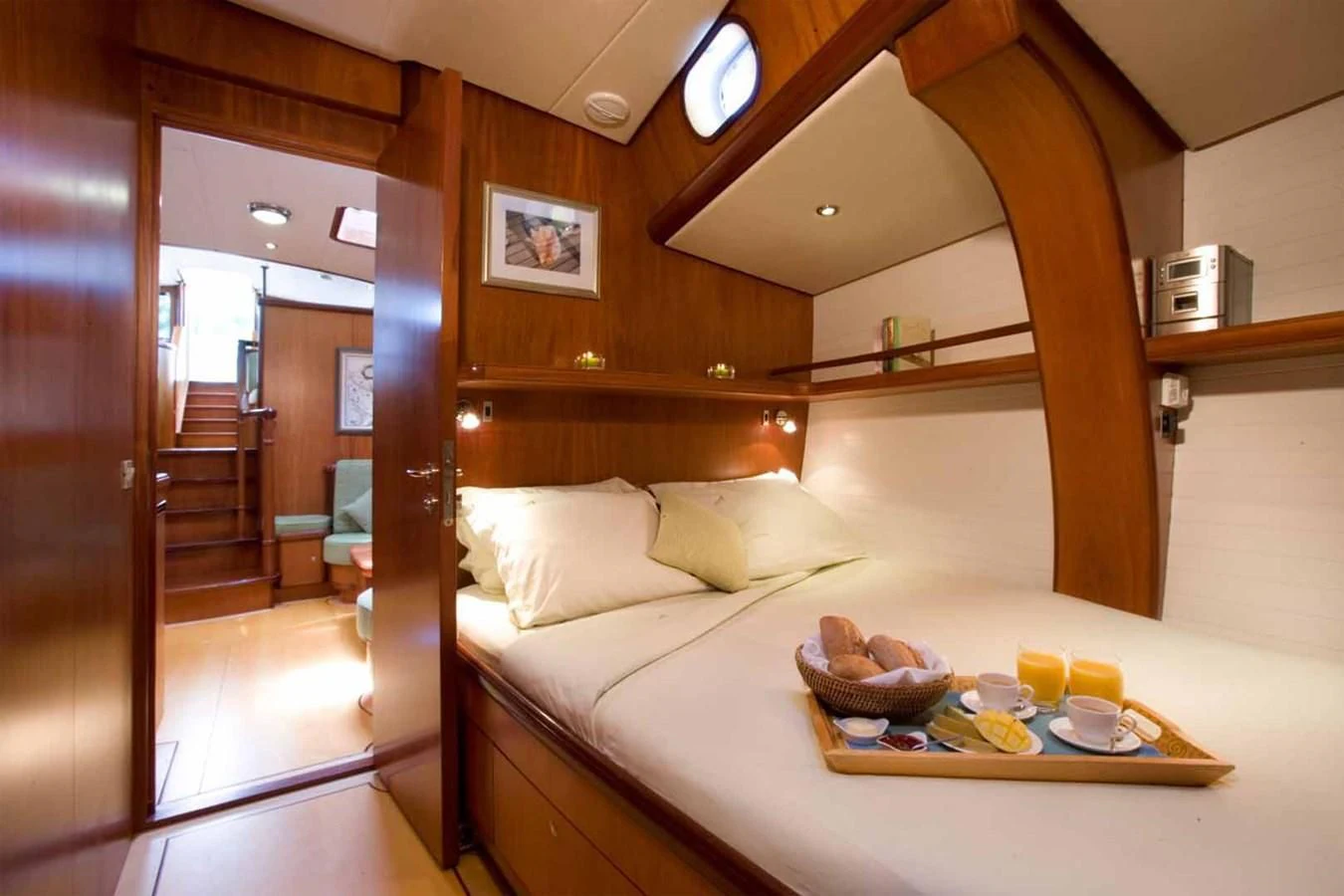 a bed with a tray of food on it aboard WHIRLWIND Yacht for Sale