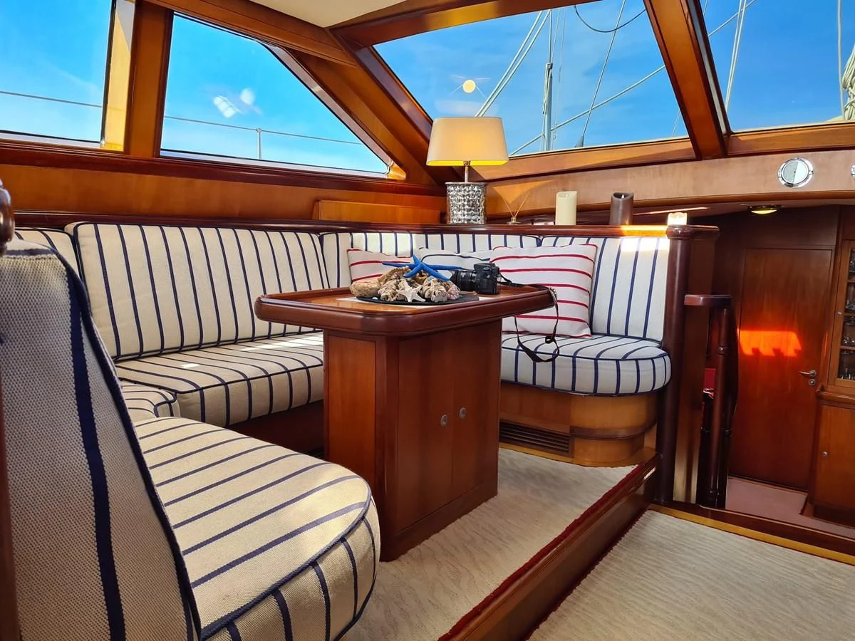 a room with a table and chairs aboard WHIRLWIND Yacht for Sale