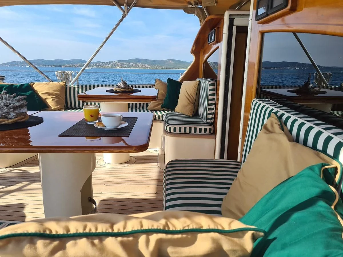 a table with a glass coffee table on a boat aboard WHIRLWIND Yacht for Sale