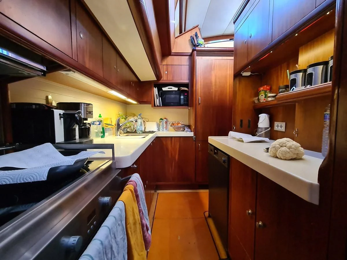 a kitchen with wooden cabinets aboard WHIRLWIND Yacht for Sale