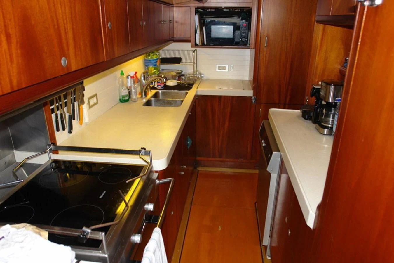 a kitchen with wooden cabinets aboard WHIRLWIND Yacht for Sale