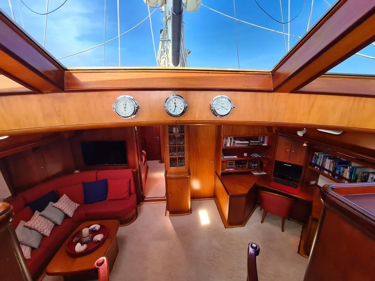 a room with a couch and a clock aboard WHIRLWIND Yacht for Sale