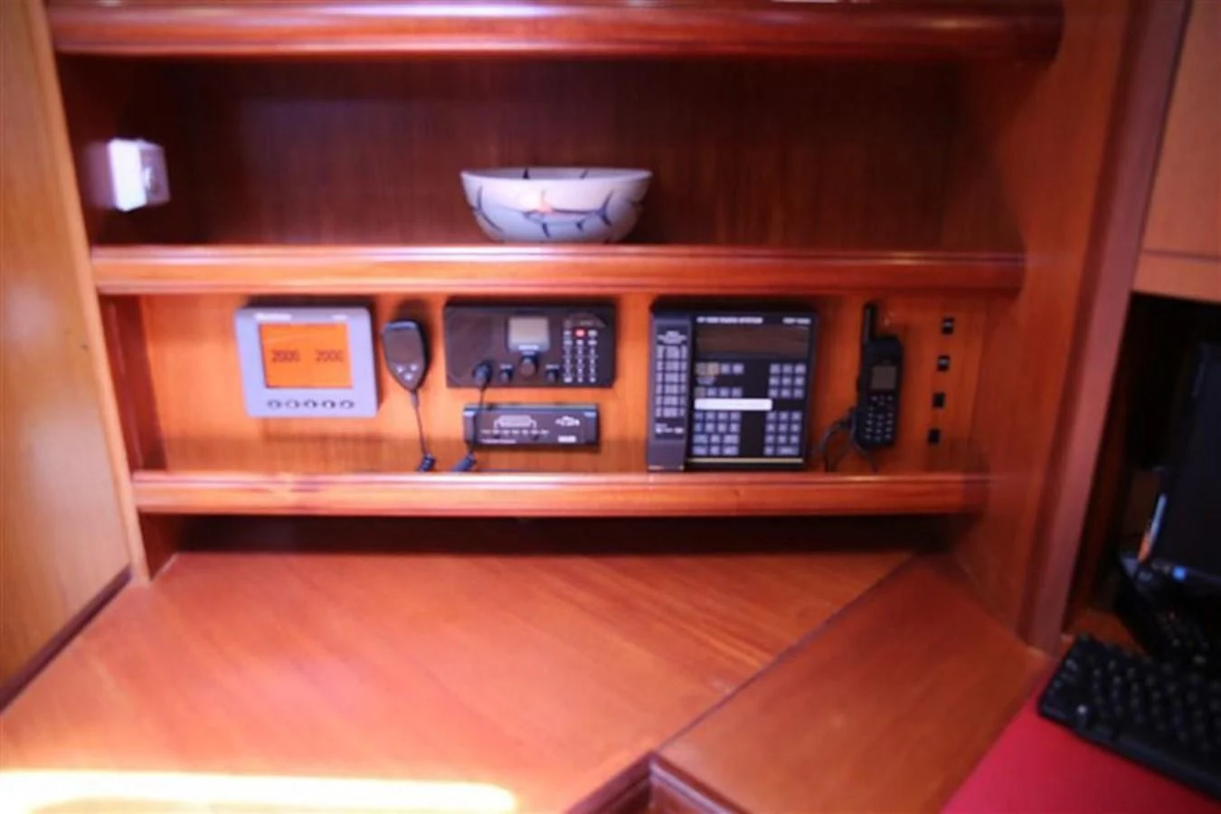 a wooden cabinet with a computer and a keyboard aboard WHIRLWIND Yacht for Sale