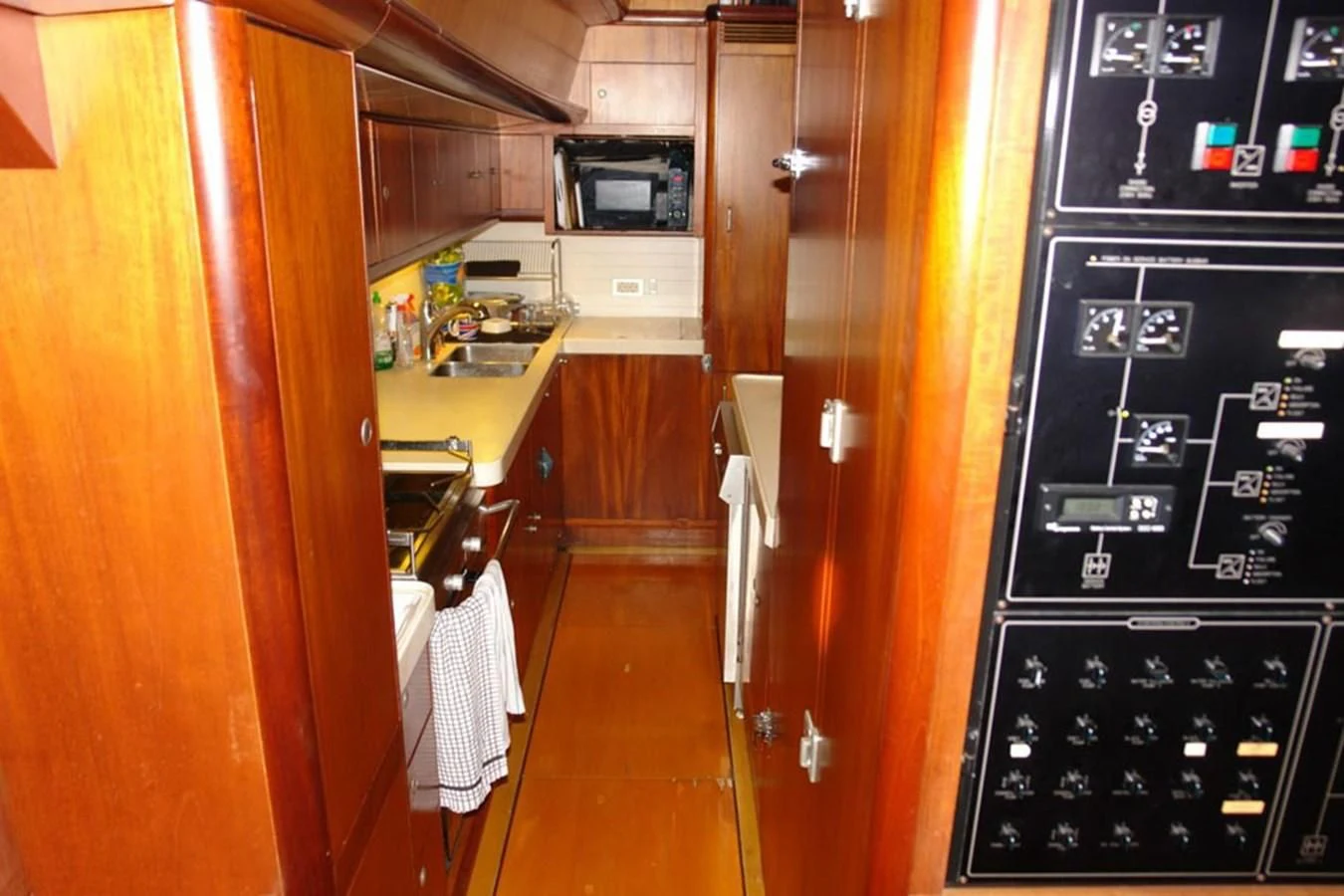 a kitchen with wooden cabinets aboard WHIRLWIND Yacht for Sale
