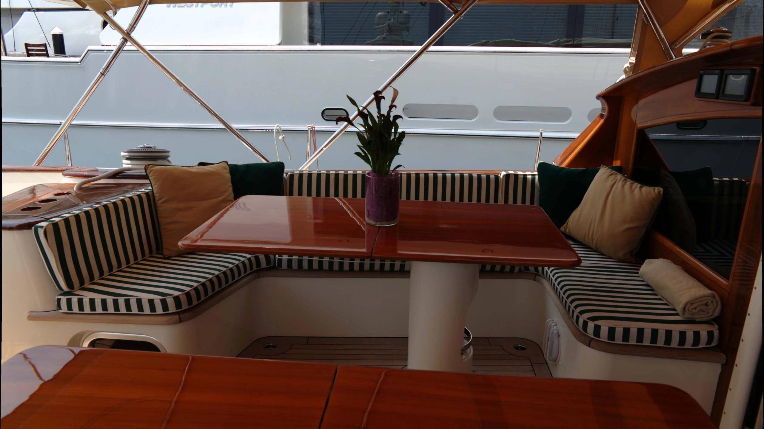 a bed with a table and a plant on it aboard WHIRLWIND Yacht for Sale