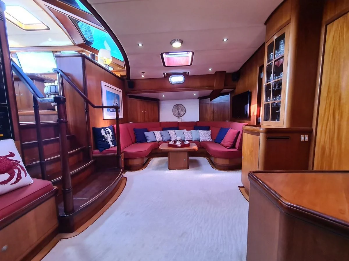 a room with a couch and a table aboard WHIRLWIND Yacht for Sale