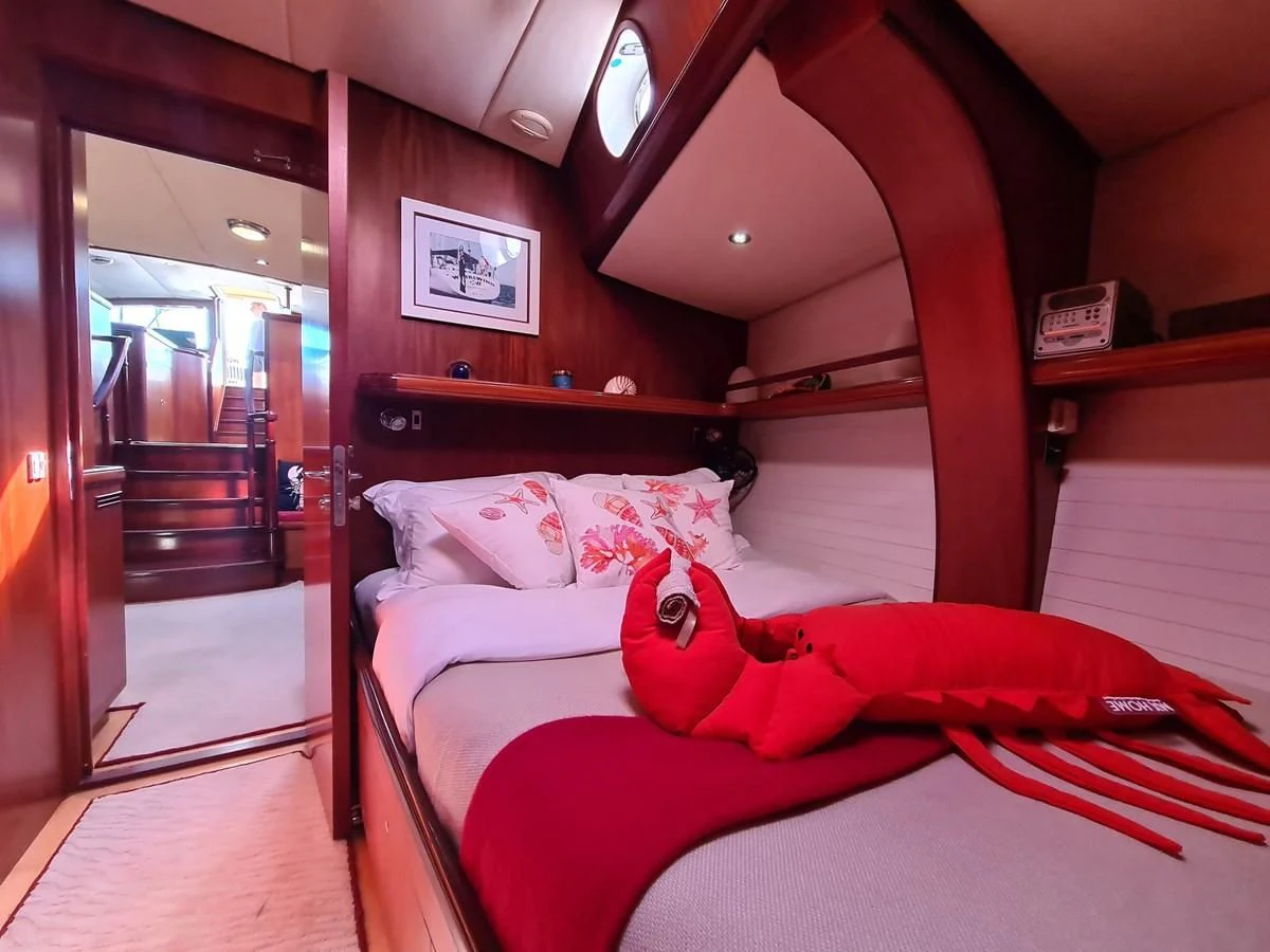 a bed with a plush toy aboard WHIRLWIND Yacht for Sale