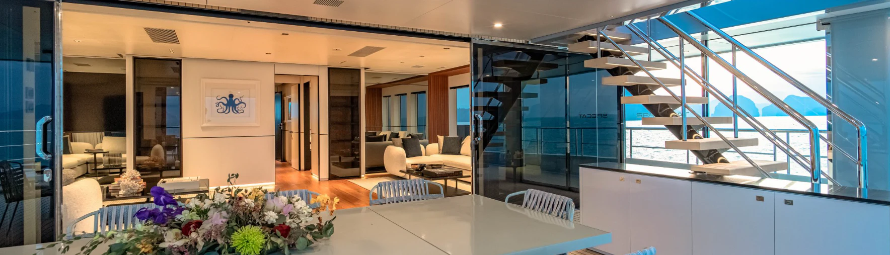 a room with a table chairs and a large window aboard SILVERCAT Yacht for Sale