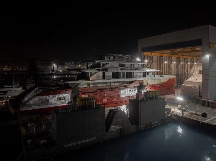 a container ship in a harbor aboard SILVER FOX Yacht for Sale