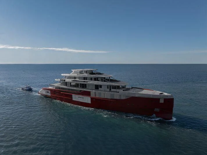 a large red boat in the water aboard SILVER FOX Yacht for Sale